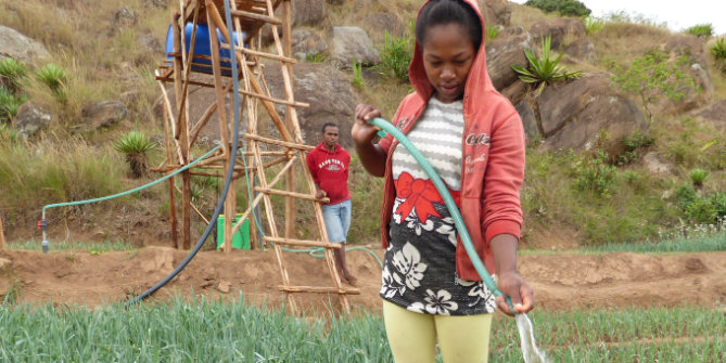 A woman using the Aqua Alimenta irrigation system